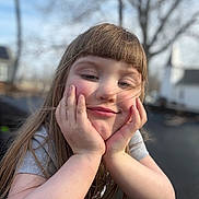 Presley joined the competition — help win amazing prizes! child, smiling, face, hands, long_hair, bangs, outdoor, nature, tree, house, portrait, casual, daylight, person, happy, young, cute, skin, expression, relaxed