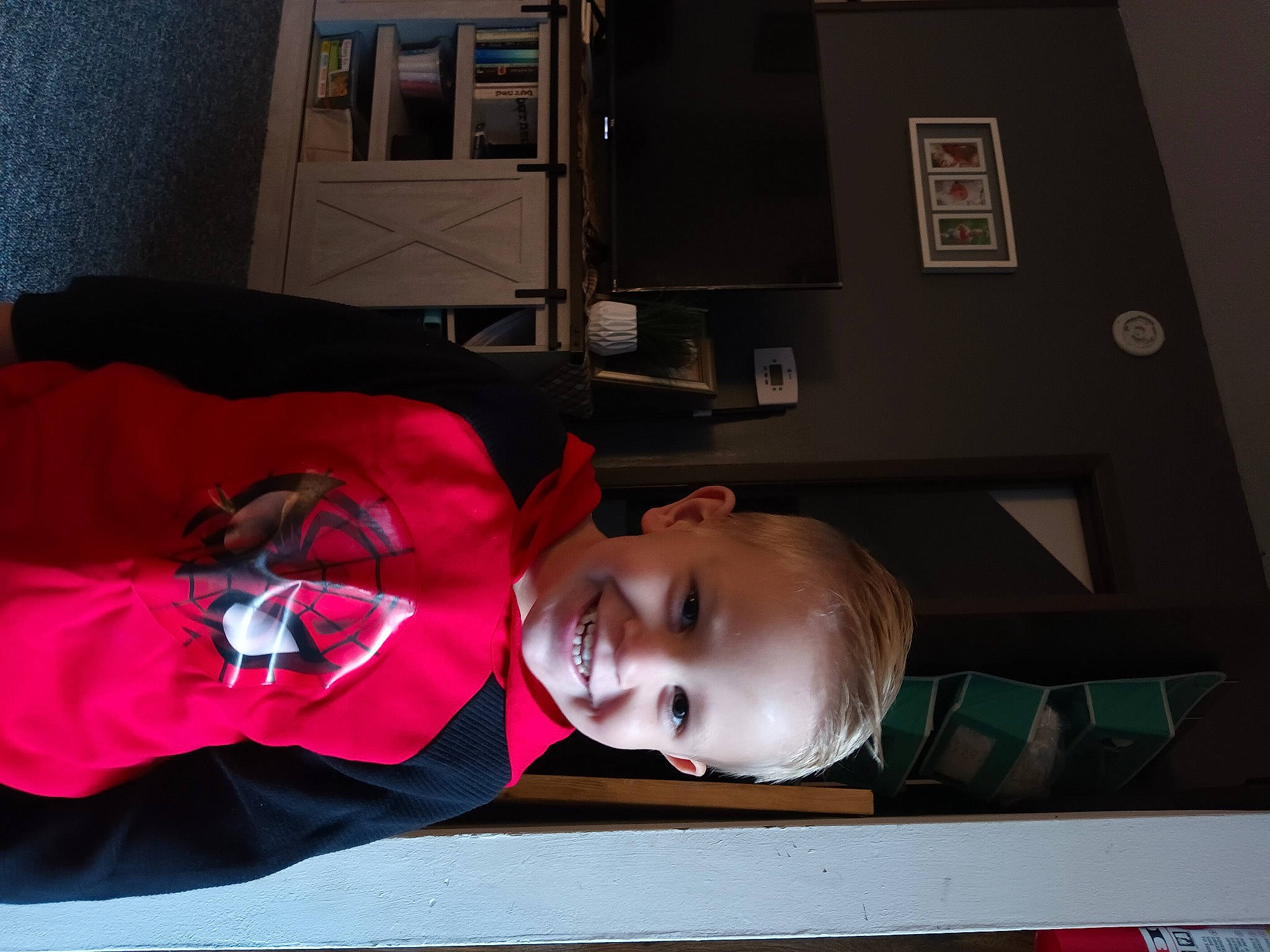 Kyler is registered to the contest to win money with this photo: audio_equipment, carmine, child, comfort, fun, joy, machine, person, personal_protective_equipment, room, t_shirt, toddler