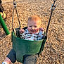 baby, child, infant, swing, bucket_swing, playground, park, wood_chips, smile, happy, outdoors, sunny, onesie, socks, metal_chain, seat, portrait, candid, playtime, grass