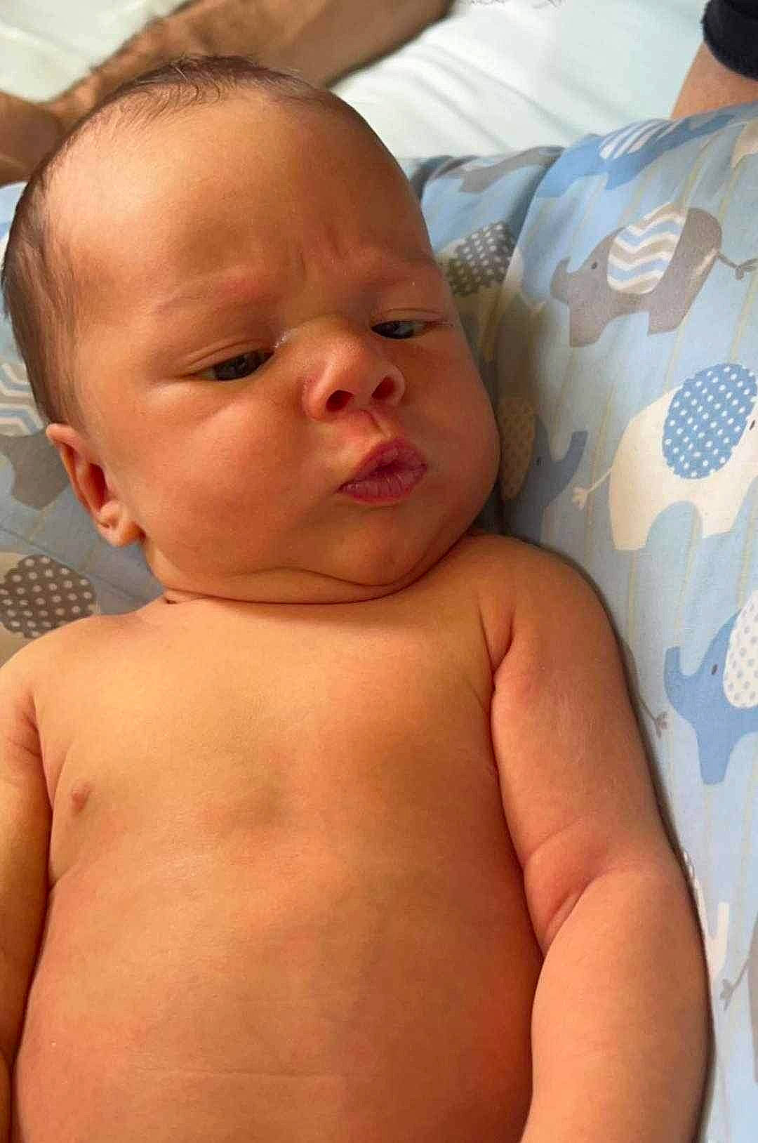 Paxton is registered to the contest to win money with this photo: arm, baby, cheek, chest, chin, comfort, eye, eyebrow, eyelash, finger, hand, head, human_body, lip, mouth, muscle, neck, nose, person, skin