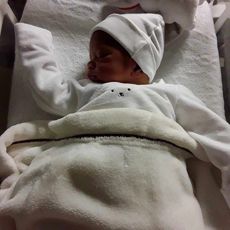 Isaac a rejoint le concours — aidez-le/la à gagner de superbes lots ! architecture, baby, bed, blanket, building, clothing, crib, face, furniture, hat, head, hospital, infantbed, newborn, person, photography, portrait, quilt, sleeping, towel