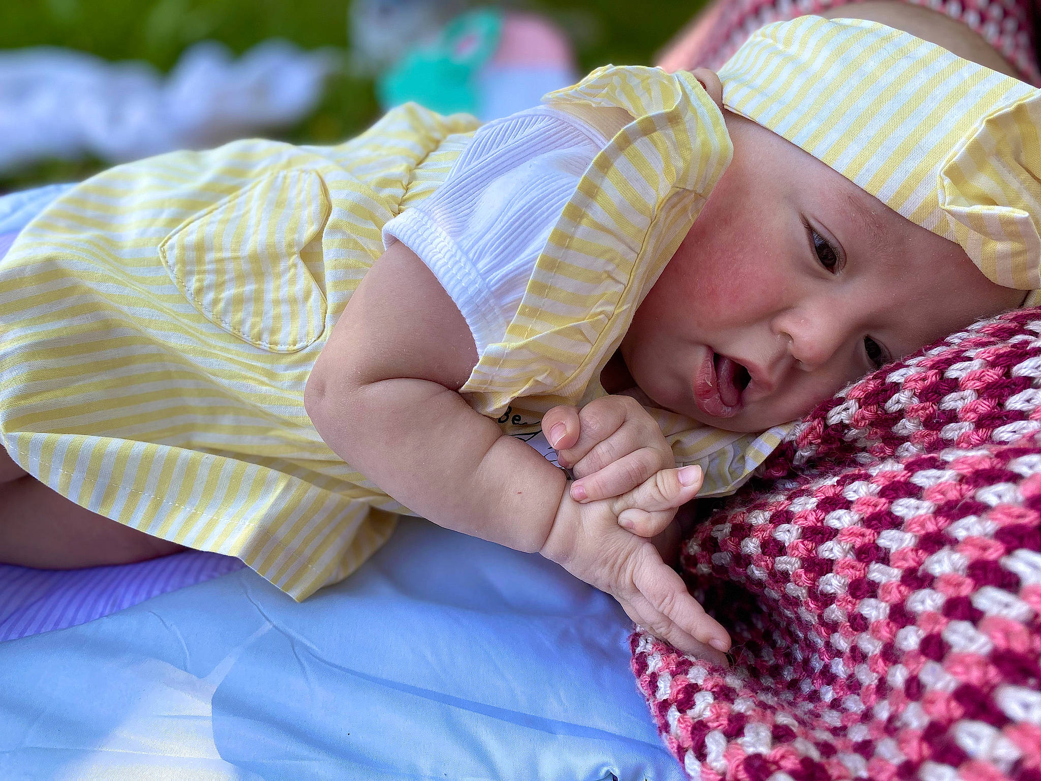 Genesis is registered to the contest to win money with this photo: baby, baby_products, baby_toddler_clothing, bedtime, child, comfort, fashion_accessory, grass, hand, happy, hat, headwear, linens, pattern, person, portrait_photography, sitting, skin, sleep, textile