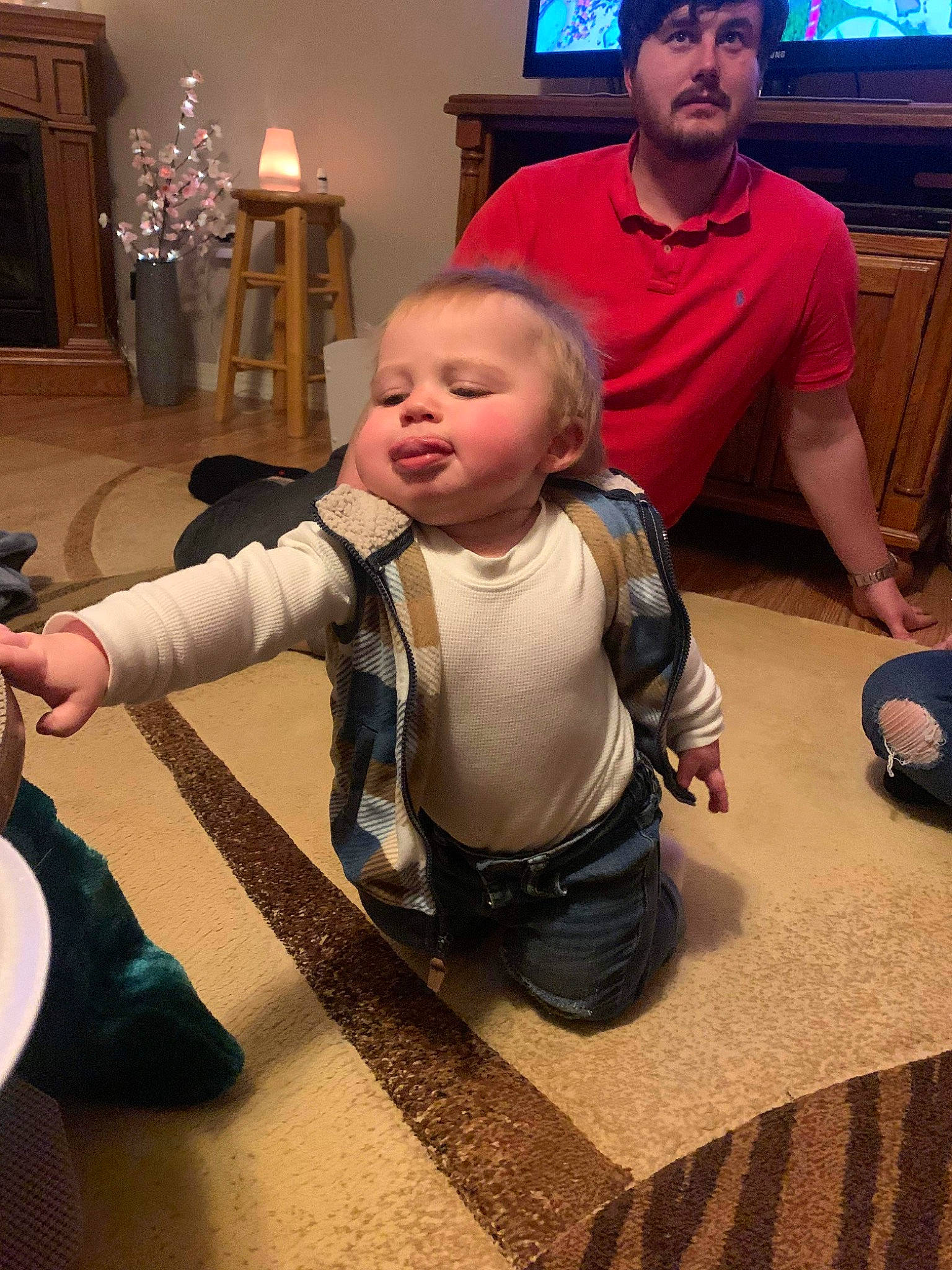 Aiden joined the competition — help win amazing prizes! baby, cabinetry, child, couch, event, floor, flooring, fun, holiday, lap, living_room, people, person, room, shoe, sneakers, standing, television, television_set, toddler