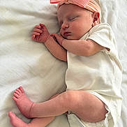 Phoebe is registered to the contest to win money with this photo: baby, sleeping, infant, pink_bow, headband, white_onesie, blanket, soft, cute, peaceful, newborn, skin, foot, hand, sleep, rest, indoors, portrait, child, cozy