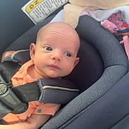 Blakelyn is registered to the contest to win money with this photo: baby, infant, car_seat, child, seatbelt, clothing, blanket, safety, cute, young, portrait, head, face, person, indoors, fabric, comfort, seat, restraint, newborn
