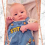 baby, infant, denim_overall, stitch, blue_eyes, cute, child, portrait, close_up, marble_background, frame, rose_gold, soft_blanket, casual_clothing, indoor, baby_clothes, small_hand, adorable, young_child, looking_at_camera