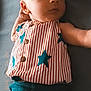 Jamison joined the competition — help win amazing prizes! baby, infant, child, striped_shirt, blue_stars, blue_pants, lying_down, soft_surface, curious, calm, portrait, cute, young, clothing, face, small_hand, indoors, casual, resting, newborn