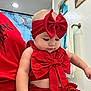 Jenny joined the competition — help win amazing prizes! baby, child, red_clothing, headband, bow, indoor, bathroom, towel, wall_art, adult, person, cute, chubby_cheeks, portrait, holding, casual, fashion, infant, skin, expression