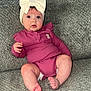 baby, infant, child, headband, bow, purple_outfit, couch, gray_couch, texture, foot, toes, sitting, curious, wide_eyes, indoor, cozy, comfortable, clothing, person, portrait
