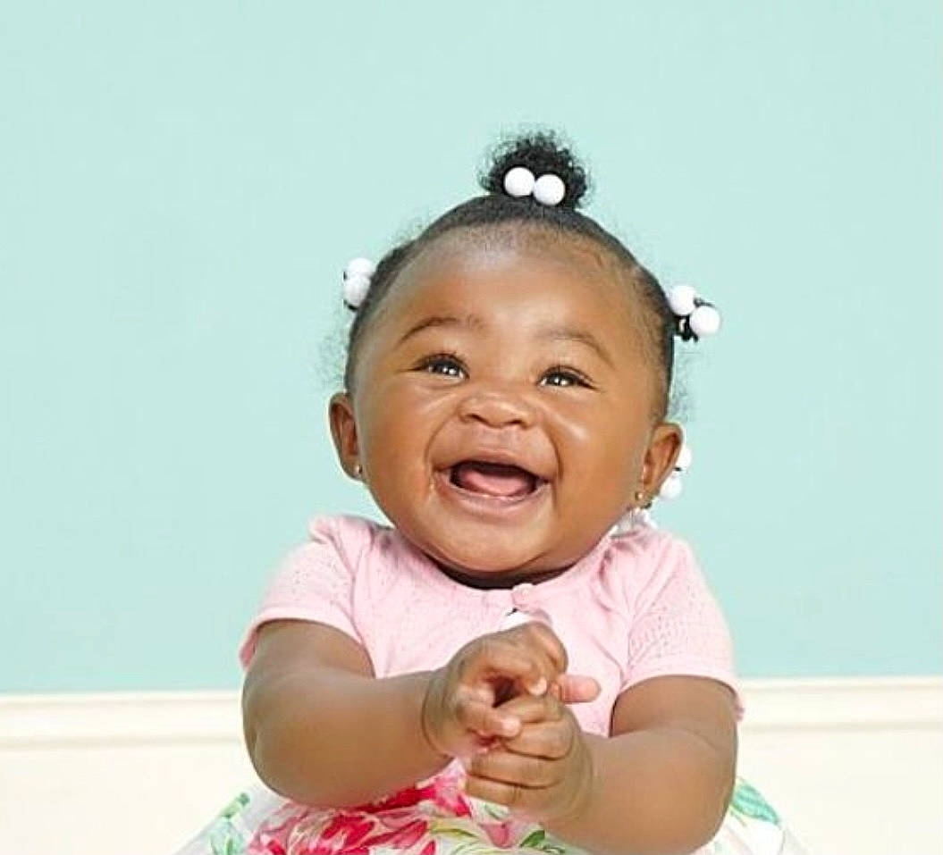 Jada is registered to the contest to win money with this photo: baby, baby_toddler_clothing, cheek, child, ear, earrings, eyelash, fashion_accessory, fun, gesture, hair_tie, happy, headband, neck, person, pink, skin, sleeve, smile, thumb