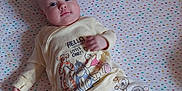 Chloe joined the competition — help win amazing prizes! baby, infant, blanket, pajamas, winnie_the_pooh, plush_toy, pooh_bear, child, cute, smiling, lying_down, bed, colorful, patterned, soft_toys, indoors, person, face, sleepwear, cozy