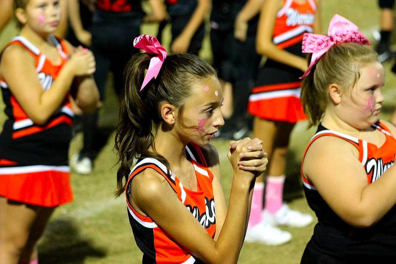 Bella is registered to the contest to win money with this photo: ball_game, cheering, cheerleading, cheerleading_uniform, competition_event, dance, dancer, entertainment, event, face, hair, person, sports, sports_uniform, team, team_sport, thigh, toddler, tournament, uniform