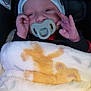 baby, pacifier, blanket, infant, car_seat, hat, hand, face, child, clothing, cozy, cute, sleepy, newborn, portrait, soft, warm, indoors, young, person