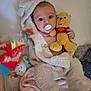 Ava a rejoint le concours — aidez-le/la à gagner de superbes lots ! baby, blanket, plush_toy, pacifier, stuffed_animal, winnie_the_pooh, child, soft_toy, toy, cozy, infant, cute, bed, sleepwear, comfort, colorful, playful, wrapped, smiling, indoor