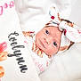 baby, newborn, infant, headband, swaddle, blanket, floral, cute, portrait, lying_down, white_background, face, eyes, soft_light, cozy, personalized, name, baby_girl, close_up, sleepwear