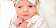 Evelynn is registered to the contest to win money with this photo: newborn, baby, infant, wrapped, blanket, headband, bow, floral, animal_print, cute, portrait, face, hands, closeup, soft, pink, white, skin, eyes, sleepy