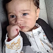 Luis participe au concours pour gagner de l'argent avec cette photo : baby, child, face, car_seat, onesie, animal_print, hand, straps, pacifier, curly_hair, indoors, portrait, close_up, cute, infant, expression, sitting, clothing, young_child, safety