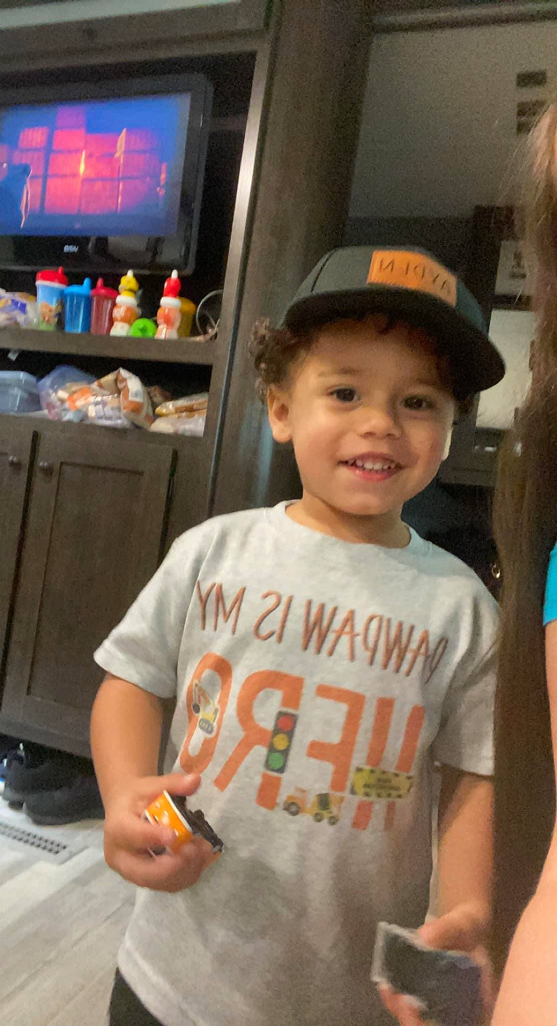 Ayden is registered to the contest to win money with this photo: baseball_cap, cap, child, event, fun, happy, hat, headwear, joy, leisure, person, room, sleeve, smile, standing, sun_hat, t_shirt, toddler, travel, vacation