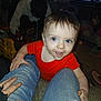 blue_eyes, child, couch, curious, family, floor, furniture, hand, home, indoor, jeans, living_room, people, person, playtime, red_shirt, smiling, television, toddler, toy