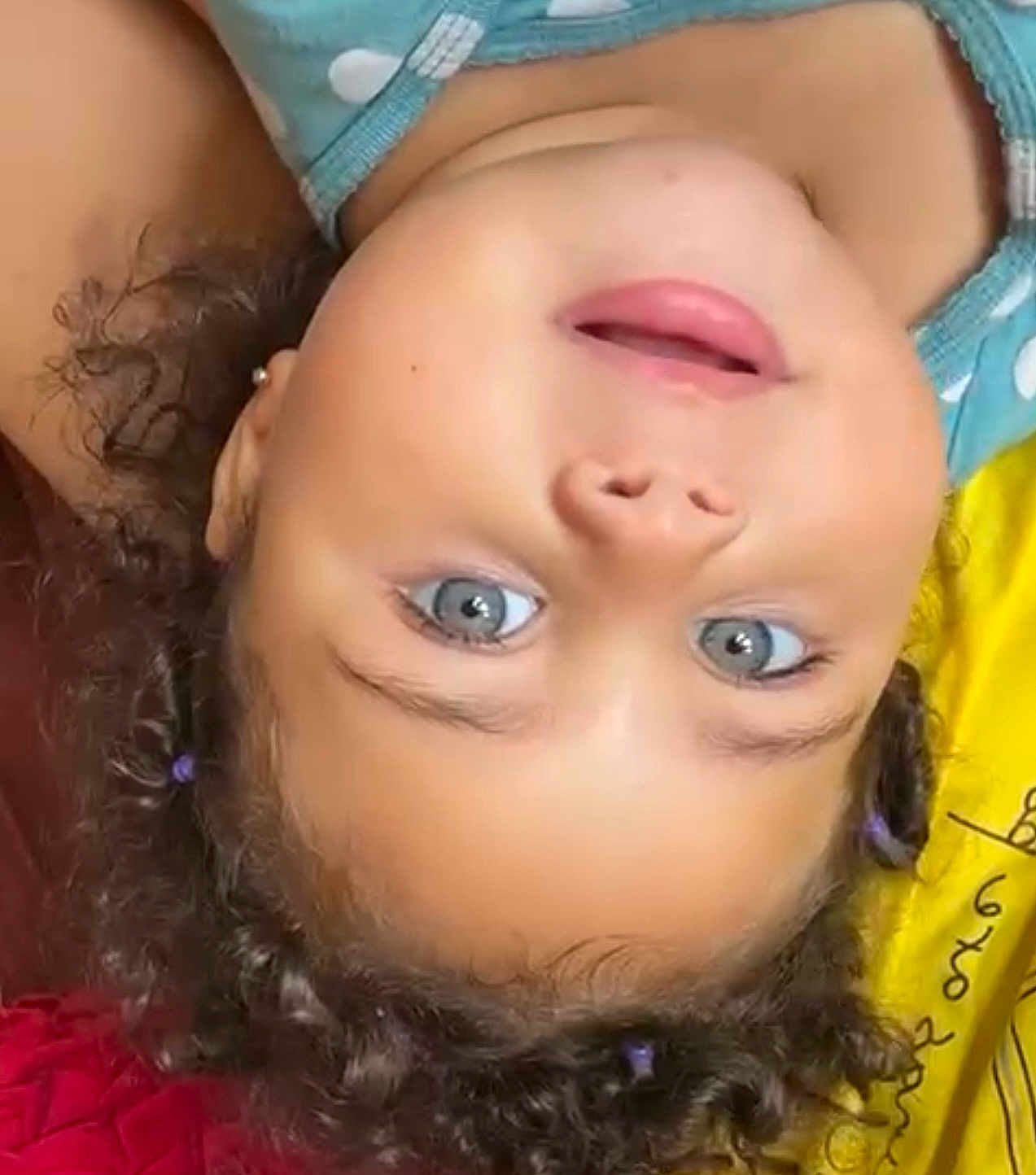 Aylla joined the competition — help win amazing prizes! blue_eyes, child, close_up, clothing, curly_hair, cute, earring, expression, face, happy, indoor, lying_down, person, polka_dot, portrait, red_fabric, skin, smiling, toddler, yellow_fabric