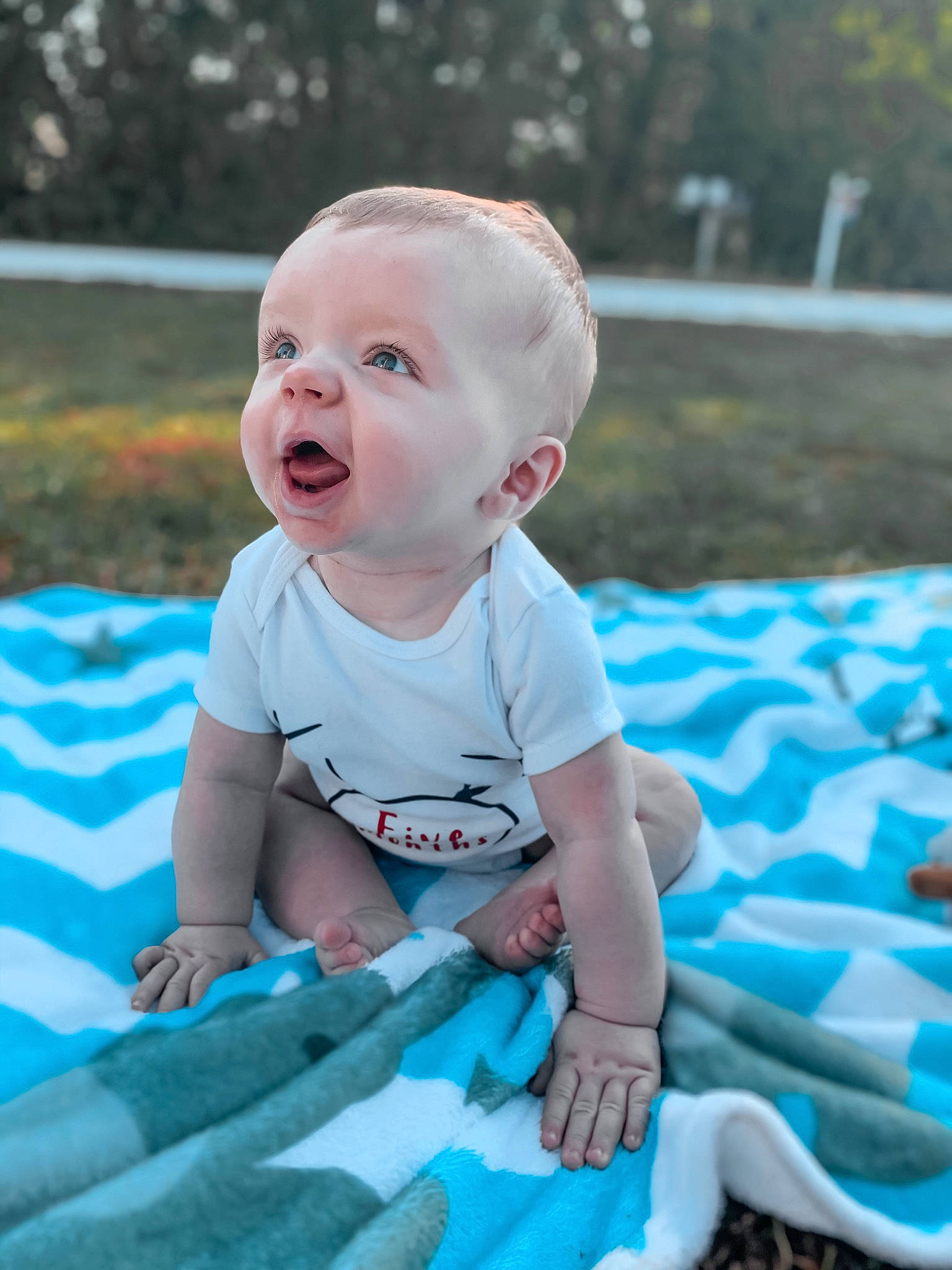 Edward is registered to the contest to win money with this photo: baby, baby_products, baby_toddler_clothing, blue, child, fun, grass, leisure, person, play, product, recreation, sitting, skin, smile, summer, toddler, turquoise, vacation