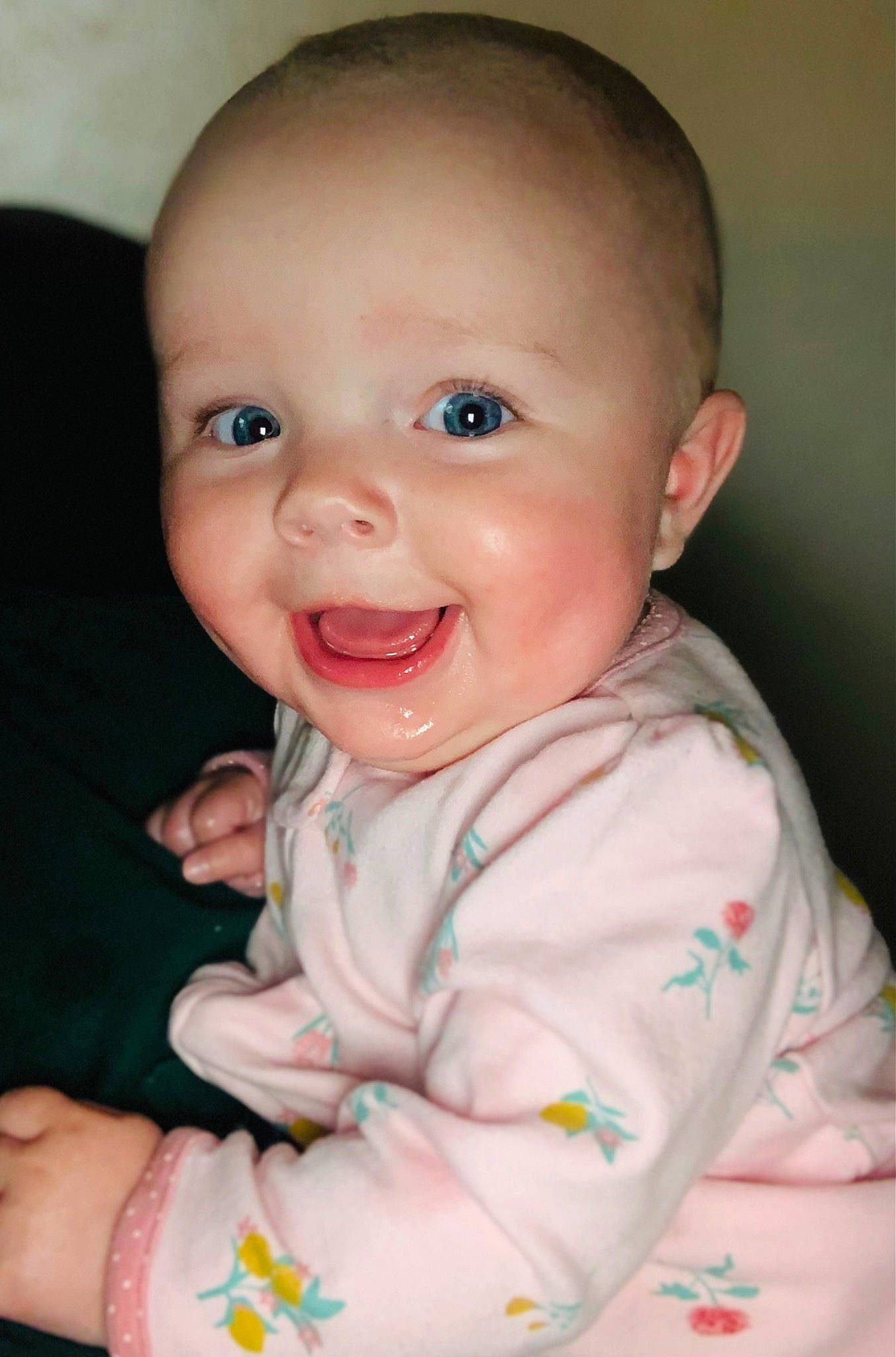 Nora is registered to the contest to win money with this photo: baby_toddler_clothing, cheek, chin, dress, eye, eyebrow, facial_expression, gesture, hand, happy, human_body, iris, joy, lip, mouth, neck, nose, person, skin, sleeve