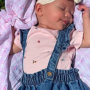 Verity is registered to the contest to win money with this photo: baby, sleeping, infant, pink, denim, overalls, headband, blanket, floral, outdoor, sunlight, peaceful, cute, child, soft, portrait, smile, clothing, young, resting