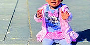 Ifunanya participe au concours pour gagner de l'argent avec cette photo : child, clothing, concrete, curious, daylight, flower, happy, headband, minnie_mouse, outdoor, person, pink_jacket, playful, shirt, sitting, sneakers, steps, sunny, toddler, young