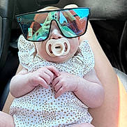 Mckenley joined the competition — help win amazing prizes! baby, pacifier, sunglasses, infant, reflection, car_interior, person, clothing, hand, legs, seat, cute, child, casual, portrait, relaxing, skin, light, summer, fashion