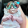 baby, pacifier, sunglasses, infant, reflection, car_interior, person, clothing, hand, legs, seat, cute, child, casual, portrait, relaxing, skin, light, summer, fashion