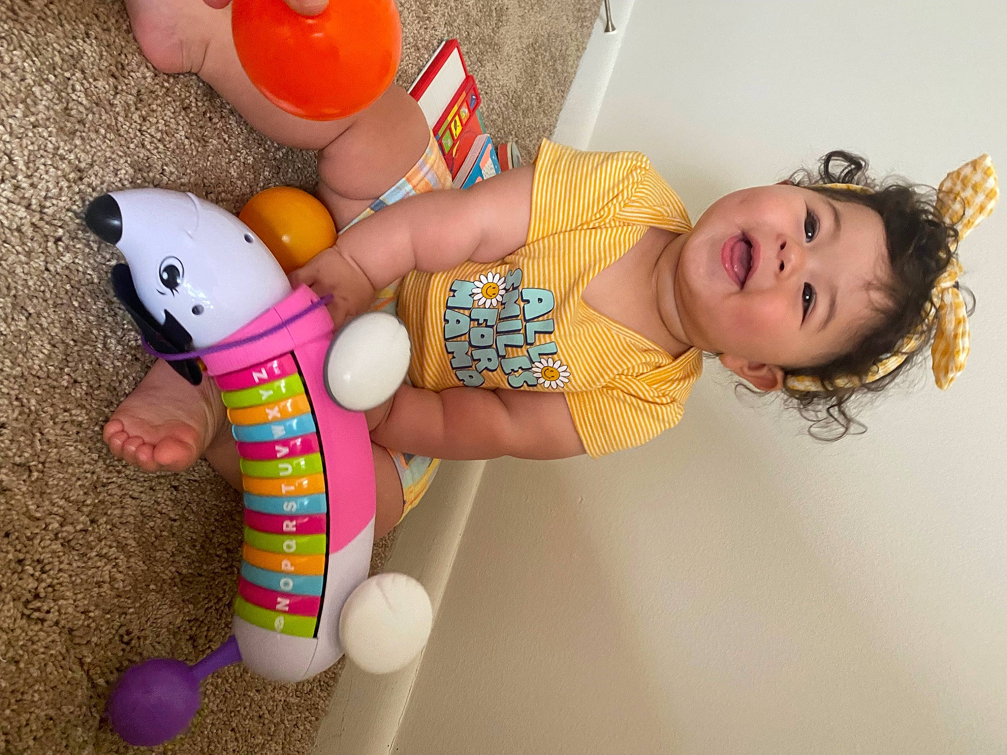 Bella joined the competition — help win amazing prizes! arm, baby, baby_toddler_clothing, child, finger, fun, hand, human_leg, joint, leg, nail, organ, party_supply, pattern, person, pink, skin, textile, thigh, toddler