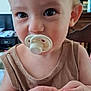 Lucas participe au concours pour gagner de l'argent avec cette photo : baby, background, child, closeup, curious, cute, expression, face, furniture, hands, holding, indoor, light_brown_hair, pacifier, person, portrait, room, skin, tank_top, young_child