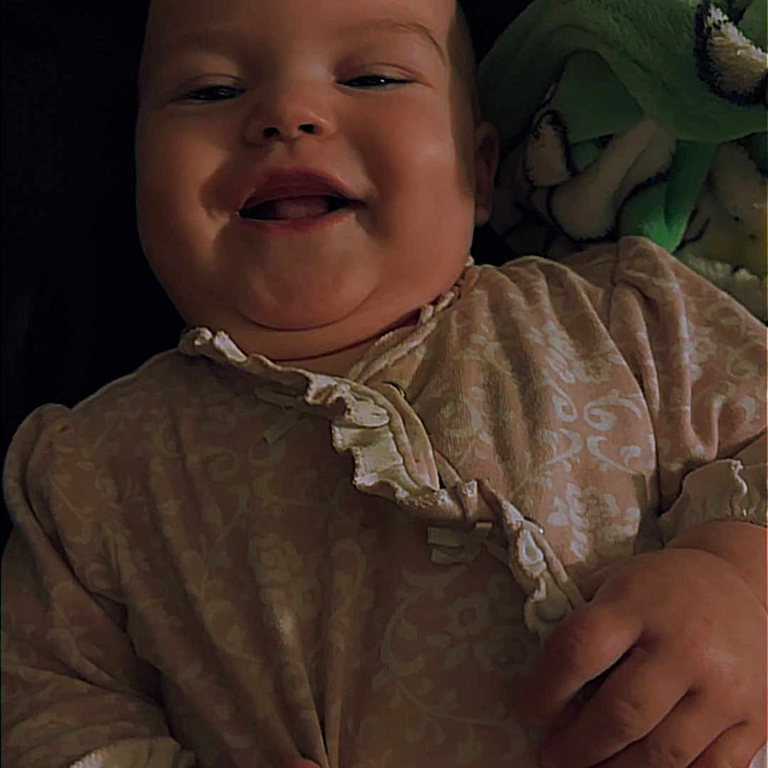 Oakley is registered to the contest to win money with this photo: applique, baby, babylaughing, bodypart, bonnet, clothing, face, finger, hand, happy, hat, head, laughing, mouth, newborn, pattern, person, photography, portrait, smile