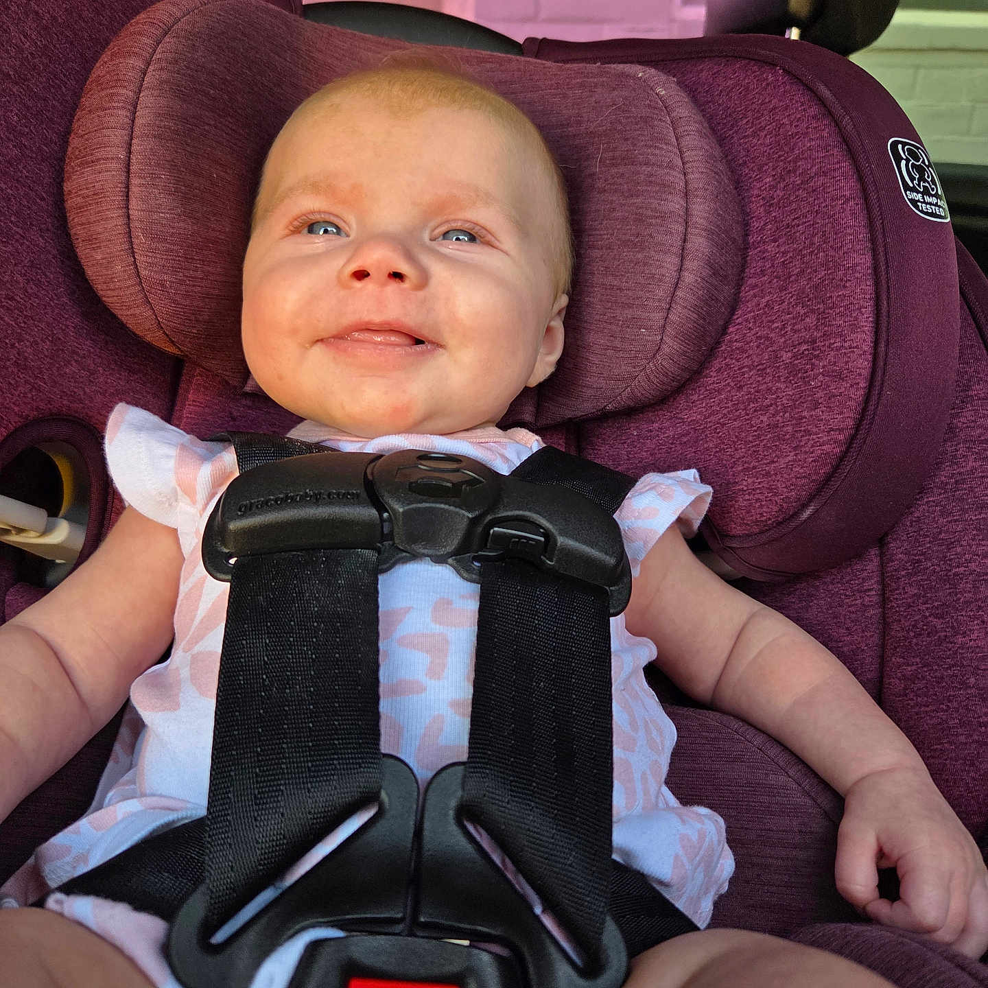 Abigail is registered to the contest to win money with this photo: baby, blue_eyes, car_seat, child, clothing, cute, fabric, happy, head_support, indoors, infant, person, pink, portrait, safety, seat, seatbelt, secure, smiling, young_child