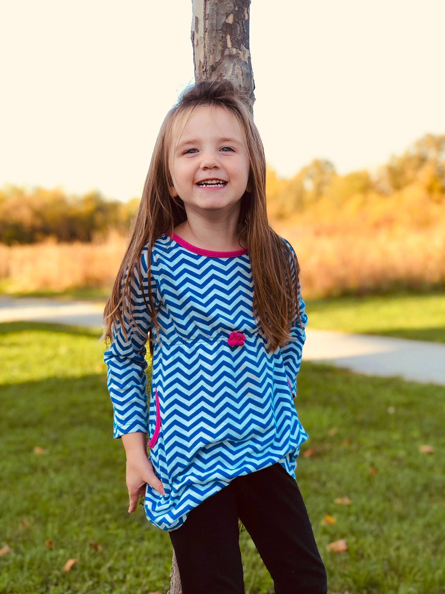 Madisen is registered to the contest to win money with this photo: blue, child, clothing, design, dress, electric_blue, grass, happy, joy, outerwear, pattern, people, person, photography, play, sleeve, smile, t_shirt, toddler, top