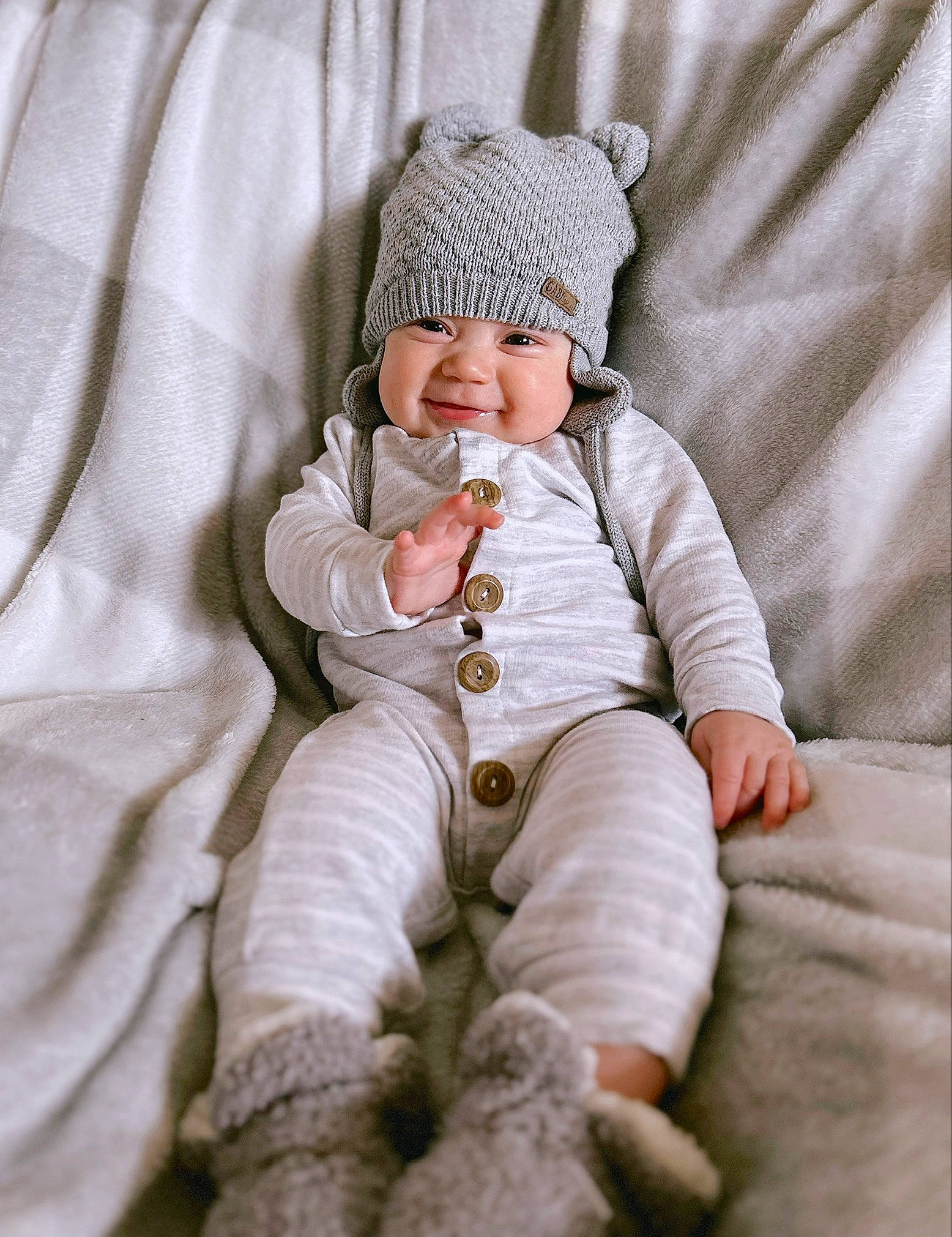 Haze is registered to the contest to win money with this photo: baby, baby_sleeping, baby_toddler_clothing, cap, child, comfort, face, foot, fur, happy, headwear, human_leg, knee, linens, peach, person, sitting, sleeve, smile, thumb