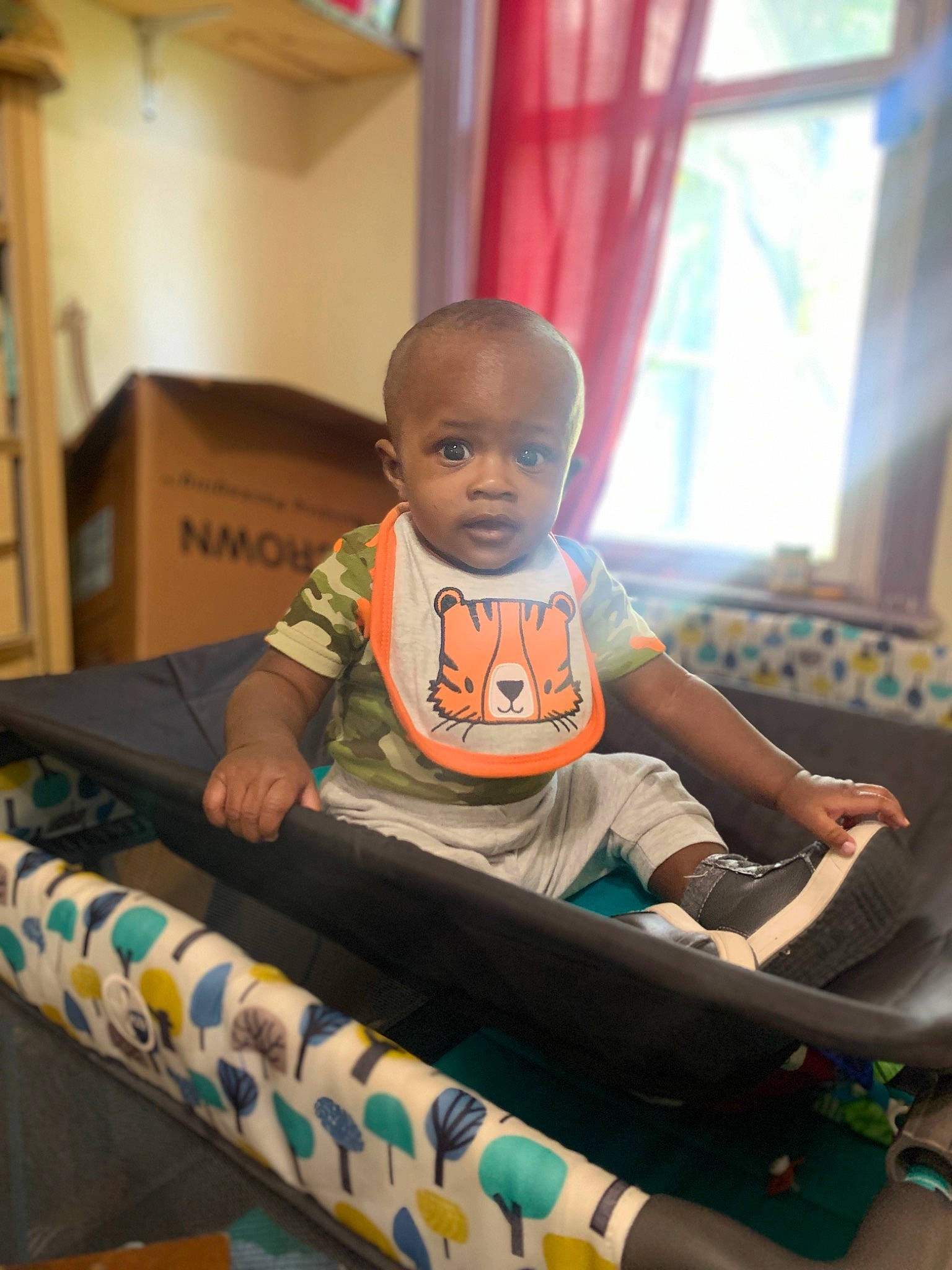 Kailand is registered to the contest to win money with this photo: arm, baby, baby_toddler_clothing, chair, child, comfort, curtain, flooring, fun, happy, hardwood, head, leisure, person, room, sitting, sleeve, t_shirt, toddler, window