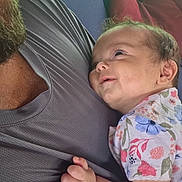 Emery is registered to the contest to win money with this photo: baby, infant, child, smiling, happy, portrait, candid, father, beard, parent, cuddling, sitting, floral_clothing, onesie, outdoor, sunlight, cushions, sofa, family, closeup