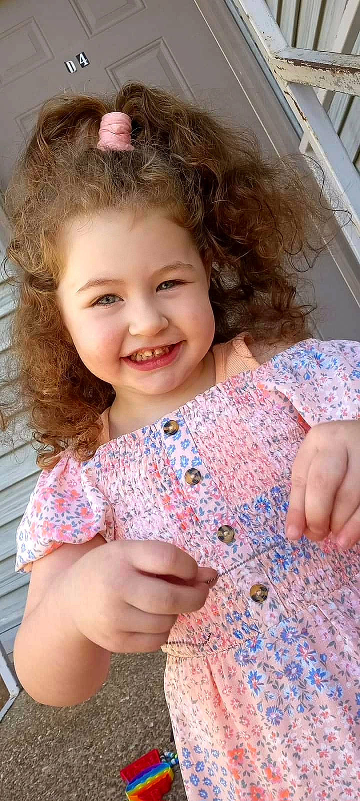 Alana is registered to the contest to win money with this photo: blond, blue, brown_hair, child, eye, face, finger, flooring, fun, hair, happy, iris, joy, linens, lip, pattern, person, pink, skin, sleeve