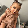 baby, baby_essentials, blurred_background, child, clothing, curious, cute, expression, face, hair, indoor, infant, pigtails, portrait, romper, seated, skin, small_child, soft_lighting, toddler