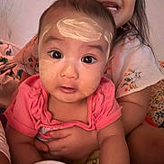 Sara is registered to the contest to win money with this photo: baby, child, face_paint, cream, smile, happy, indoor, blanket, hug, person, cute, young_child, sibling, clothing, portrait, skin, head, expression, warm, comfort