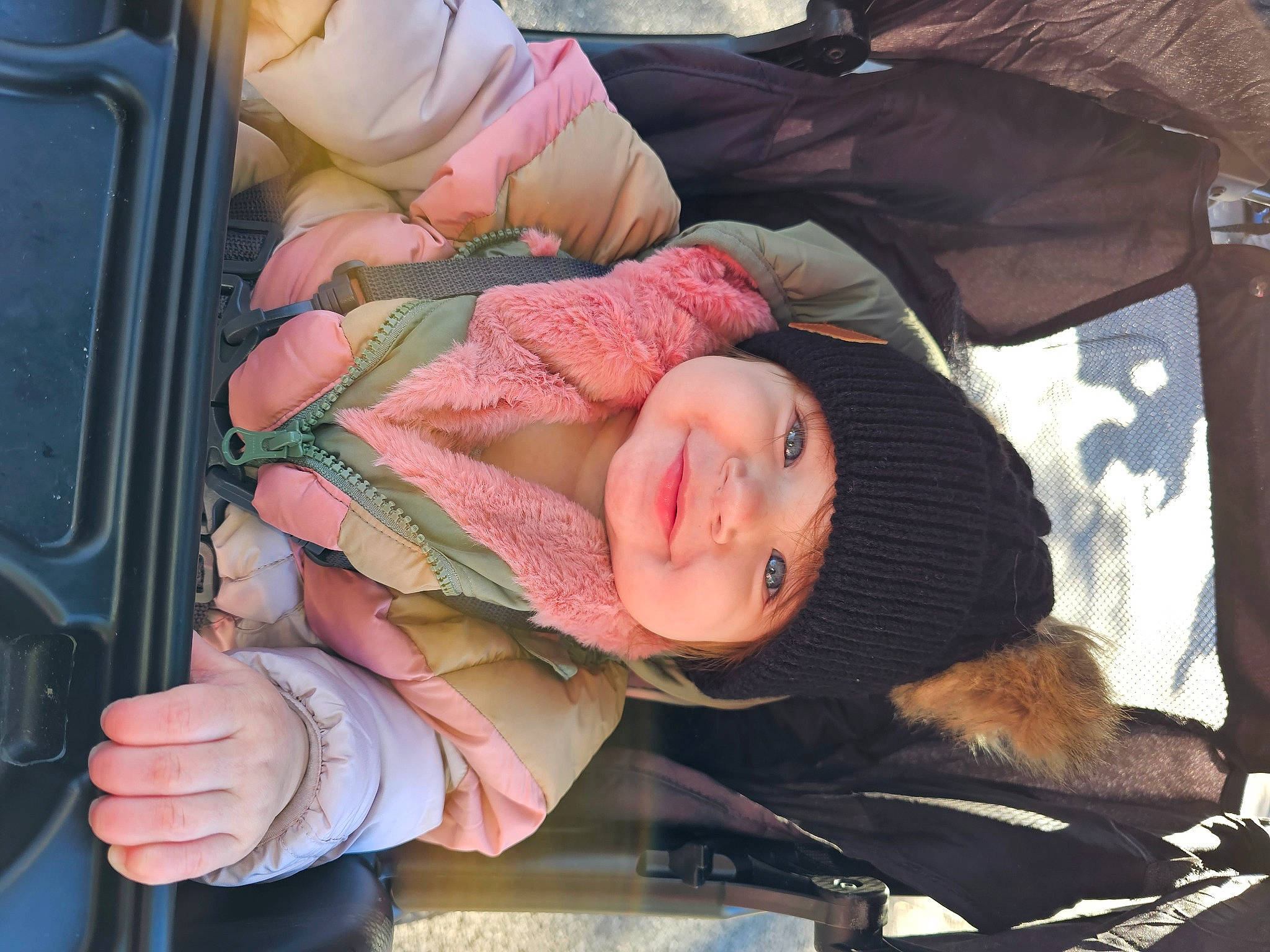 Emma is registered to the contest to win money with this photo: auto_part, automotive_exterior, baby, baby_carriage, baby_products, car_seat, child, comfort, facial_expression, family_car, finger, fun, headwear, motor_vehicle, person, seat_belt, sitting, skin, smile, toddler