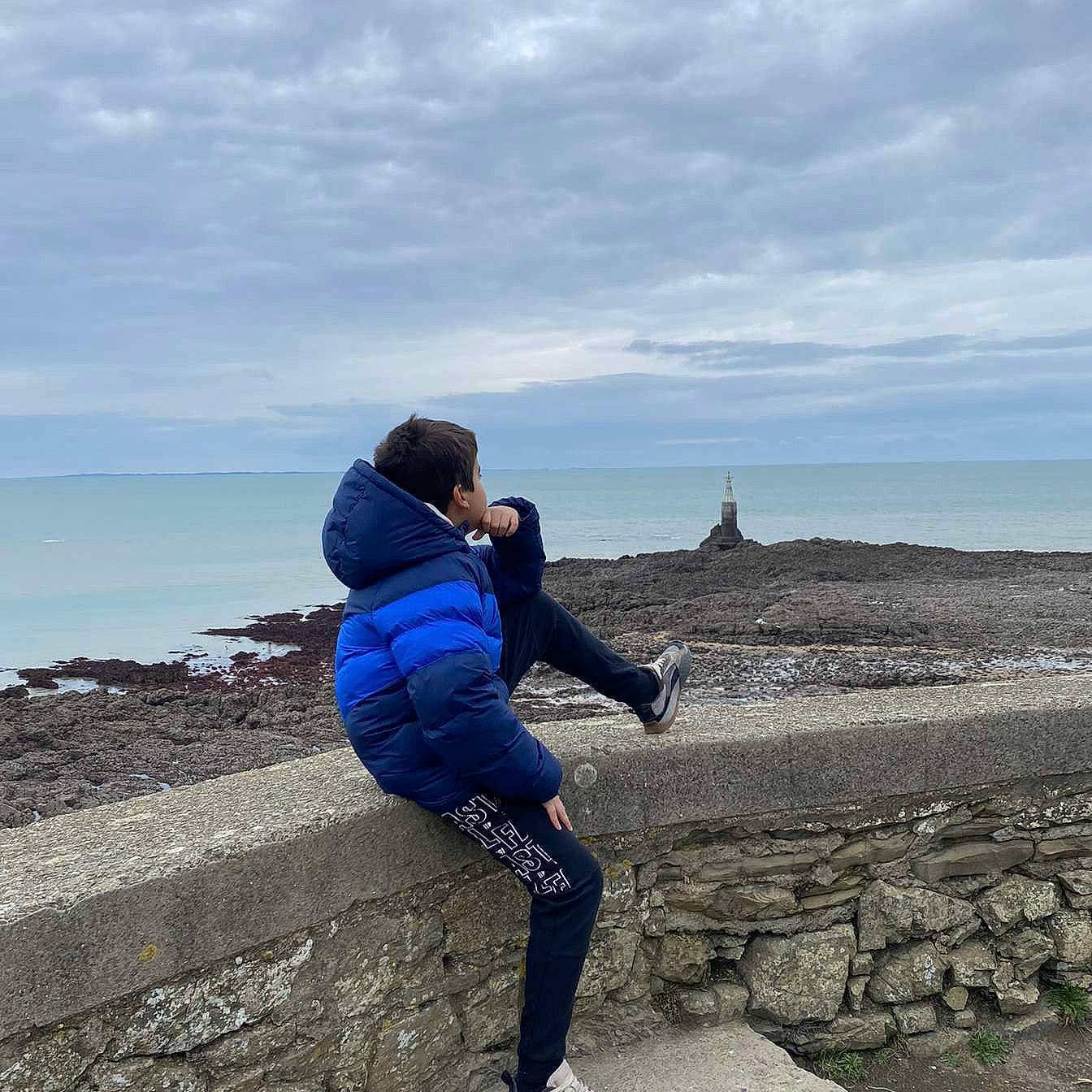 Nacim participe au concours pour gagner de l'argent avec cette photo : boot, cloud, coastal_and_oceanic_landforms, electric_blue, flash_photography, fun, happy, headland, horizon, human_leg, landscape, leisure, people_in_nature, person, recreation, rock, sky, travel, water, wind