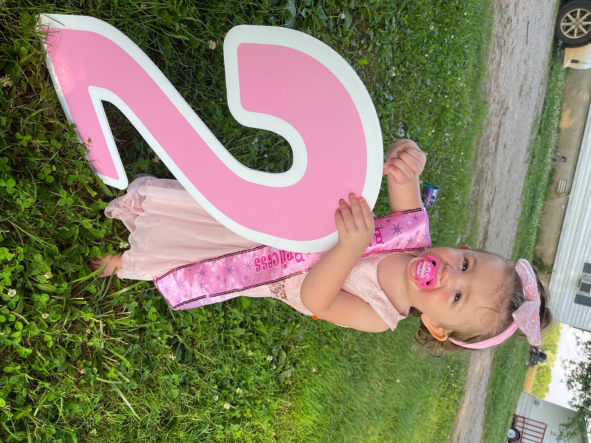 Layla is registered to the contest to win money with this photo: art, beauty, child, font, fun, garden, graphics, grass, grassland, happy, hat, leisure, magenta, people_in_nature, person, pink, plant, recreation, sandal, spring