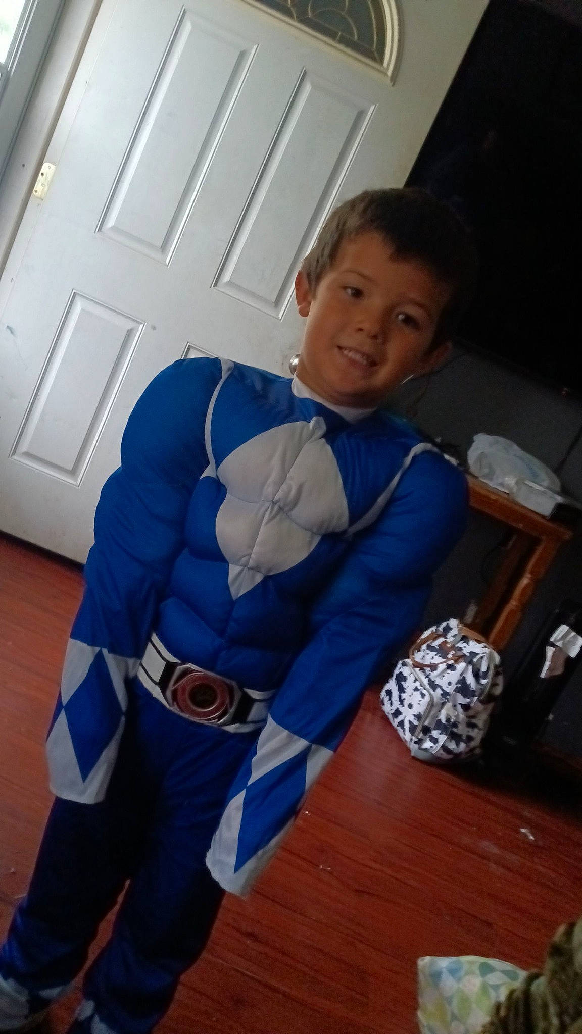 Kaiden is registered to the contest to win money with this photo: abdomen, azure, child, comfort, door, elbow, electric_blue, floor, flooring, fun, glove, hardwood, joy, person, room, sitting, sleeve, stuffed_toy, t_shirt, textile