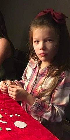 Kyannah is registered to the contest to win money with this photo: brown_hair, child, child_model, finger, games, hairstyle, hand, human, long_hair, person, play, recreation, sitting, thumb, toddler