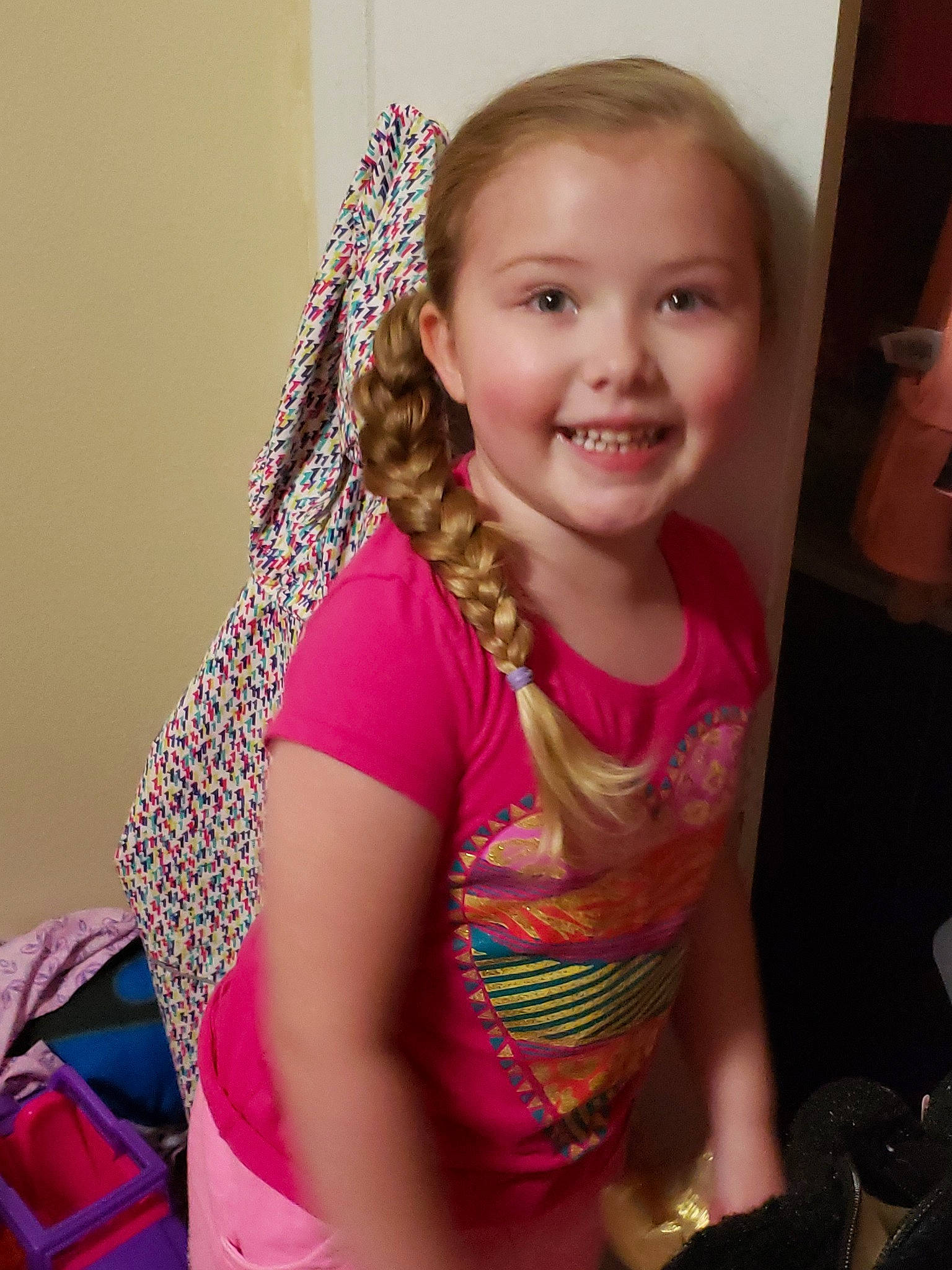 Brynn joined the competition — help win amazing prizes! arm, cheek, child, face, facial_expression, fashion_accessory, fun, hair, happy, head, joy, long_hair, neck, person, pink, room, scarf, skin, smile, toddler