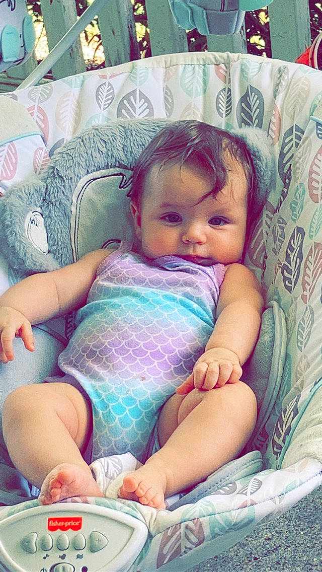 Alena is registered to the contest to win money with this photo: baby, baby_toddler_clothing, cheek, child, chin, comfort, fun, happy, iris, lap, mouth, nail, person, pink, purple, sitting, skin, textile, thigh, thumb