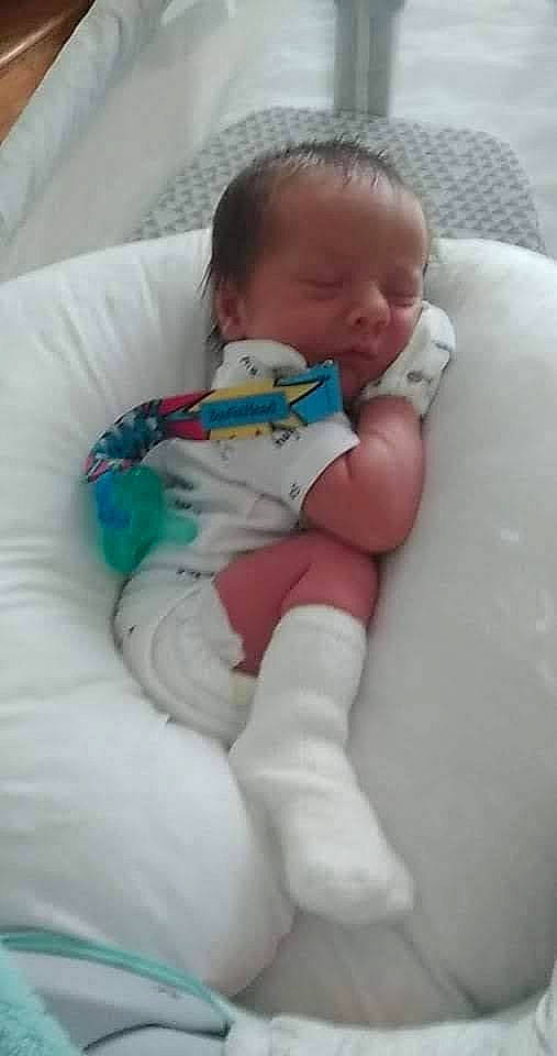 Lazarus is registered to the contest to win money with this photo: baby, baby_products, baby_toddler_clothing, bedtime, cheek, child, comfort, face, head, human_body, leg, linens, mouth, nail, person, room, sitting, skin, sock, thumb