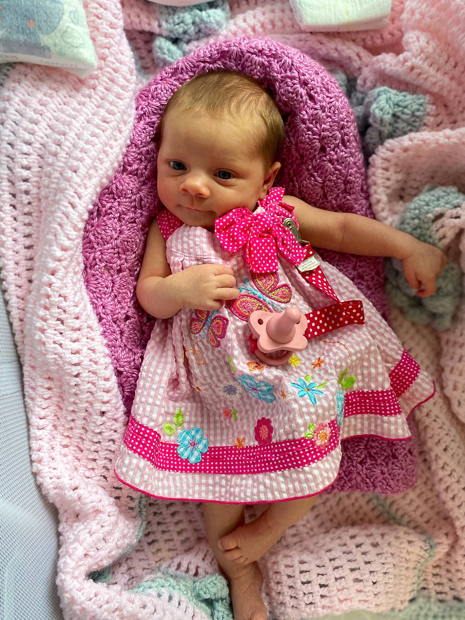 Averly joined the competition — help win amazing prizes! arm, baby, baby_products, baby_toddler_clothing, cheek, child, comfort, doll, dress, linens, magenta, pattern, person, pink, purple, skin, sleeve, textile, toddler, wool